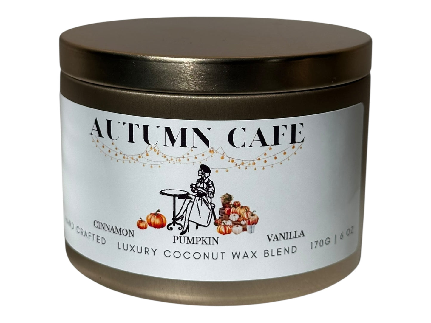 A gold candle tin  labeled 'Autumn Cafe' with a decorative label on a white background.