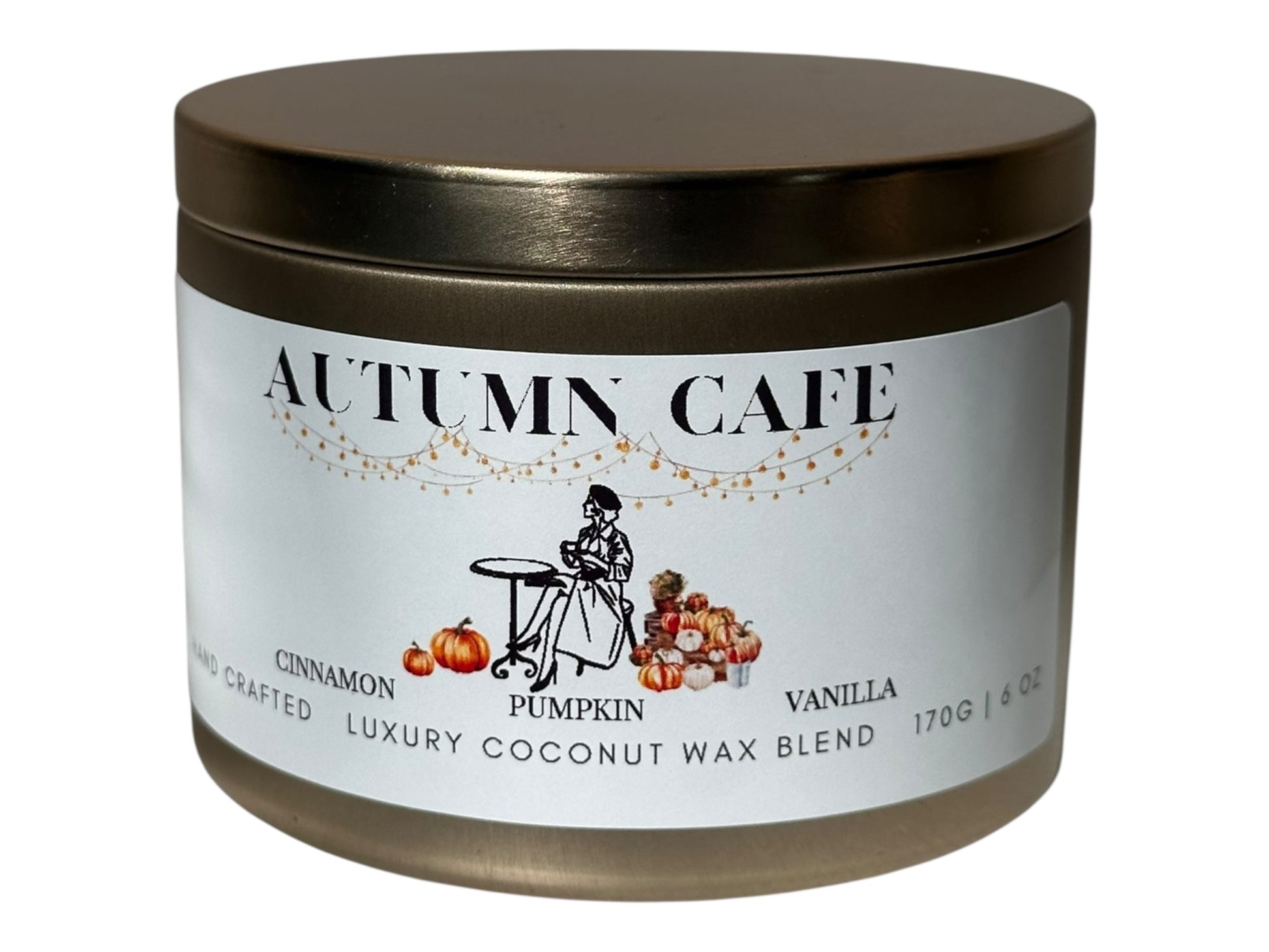 A gold candle tin  labeled 'Autumn Cafe' with a decorative label on a white background.