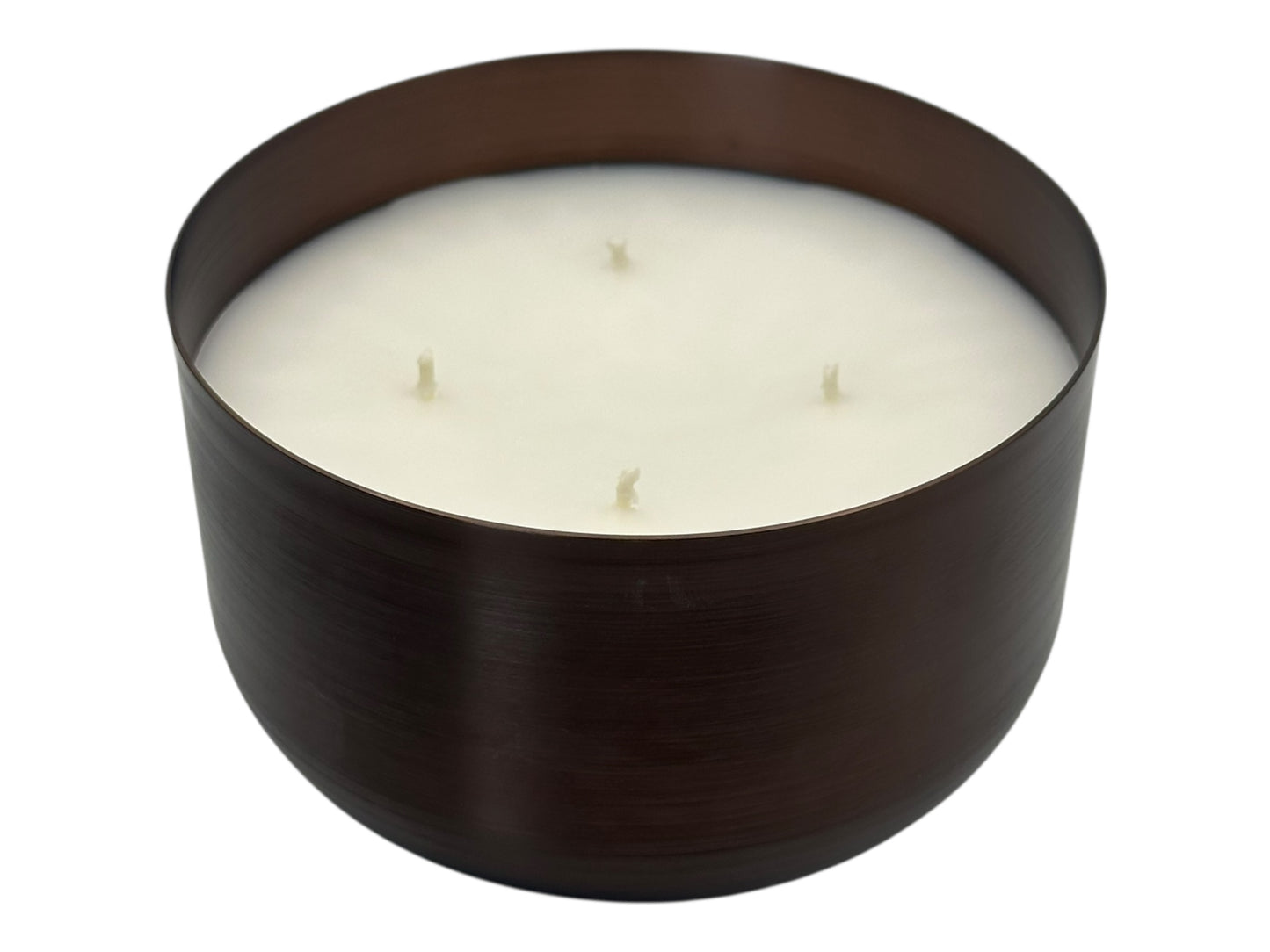 A bronze candle tin with four candle wicks and a white smooth candle top on a white background.