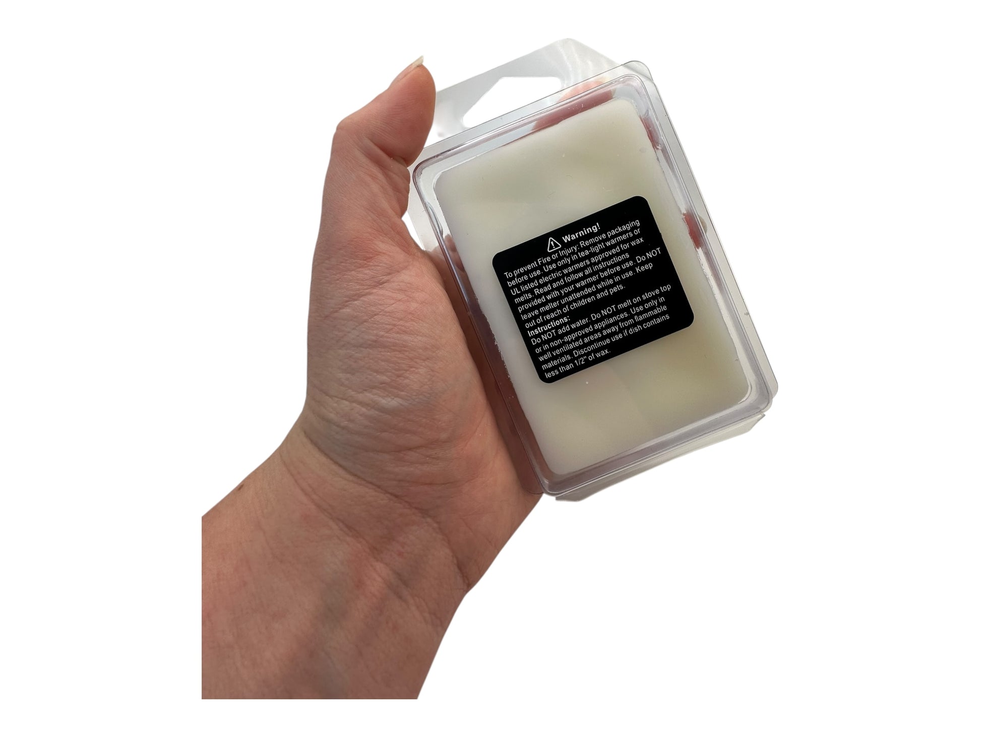 Hand holding a wax melt container with a label on a white background
