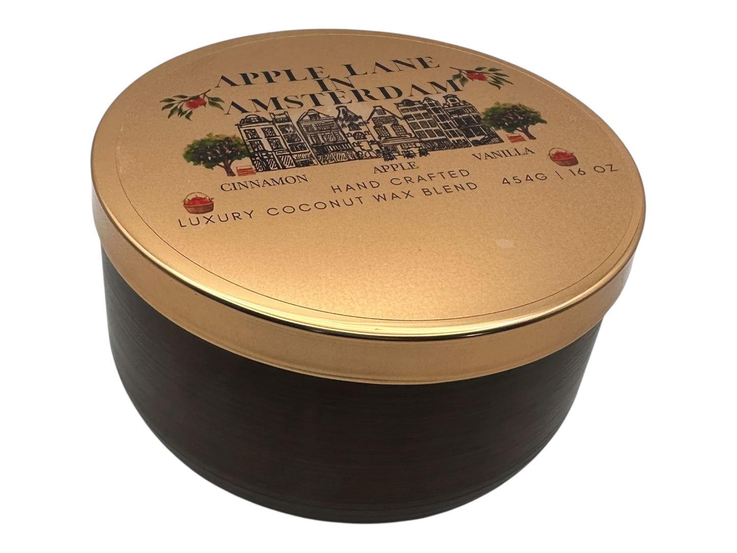 A bronze and gold candle tin labeled "Apple Lane in Amsterdam" with a decorative clear label on a white background.