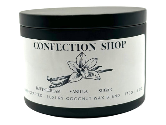 A black candle tin labeled "Confection Shop" on a white background.