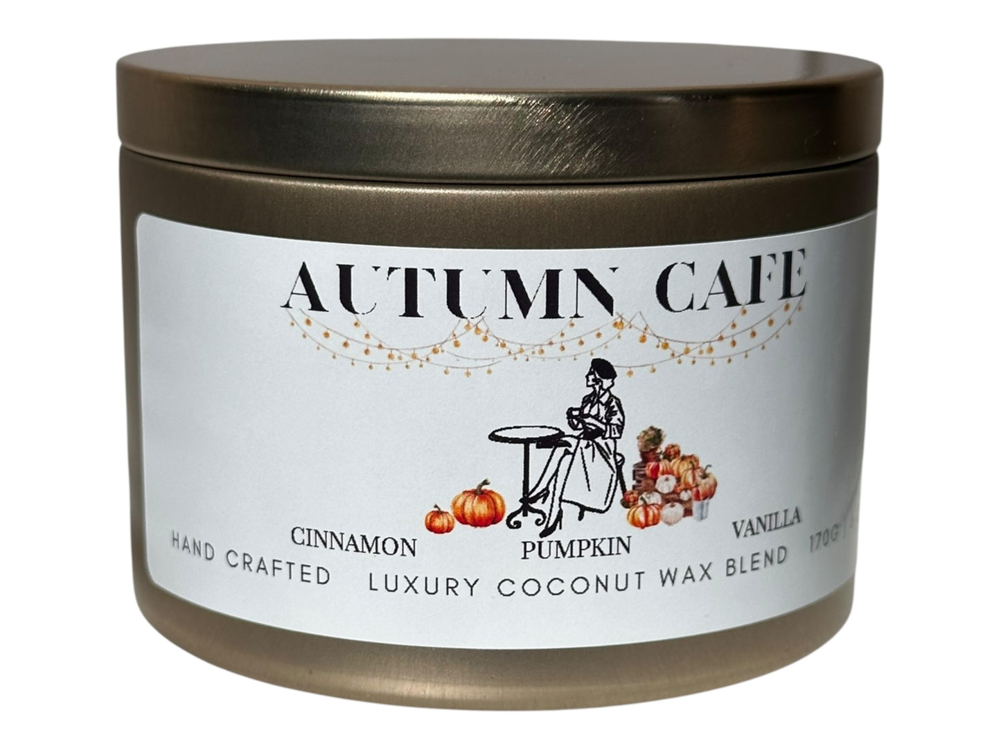 A gold candle tin  labeled 'Autumn Cafe' with a decorative label on a white background