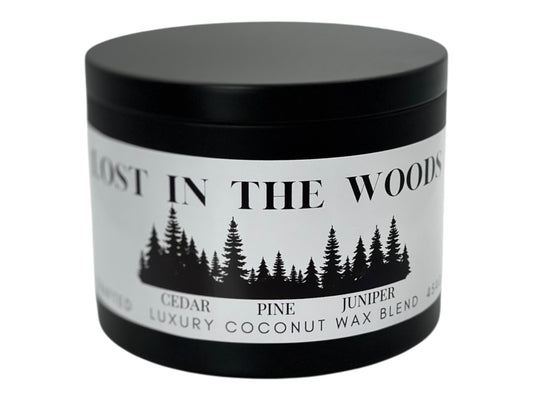 A black candle tin labeled "Lost in the Woods" on a white background.