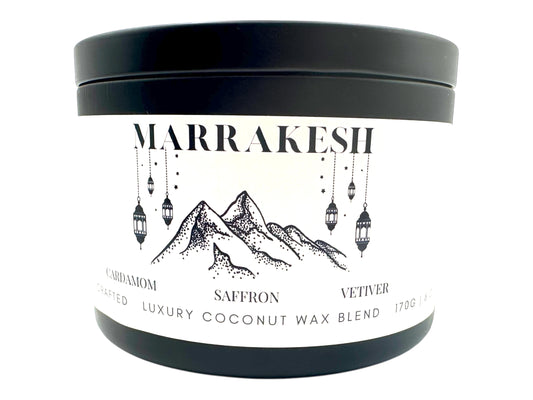 A black candle tin labeled "Marrakesh" on a white background.