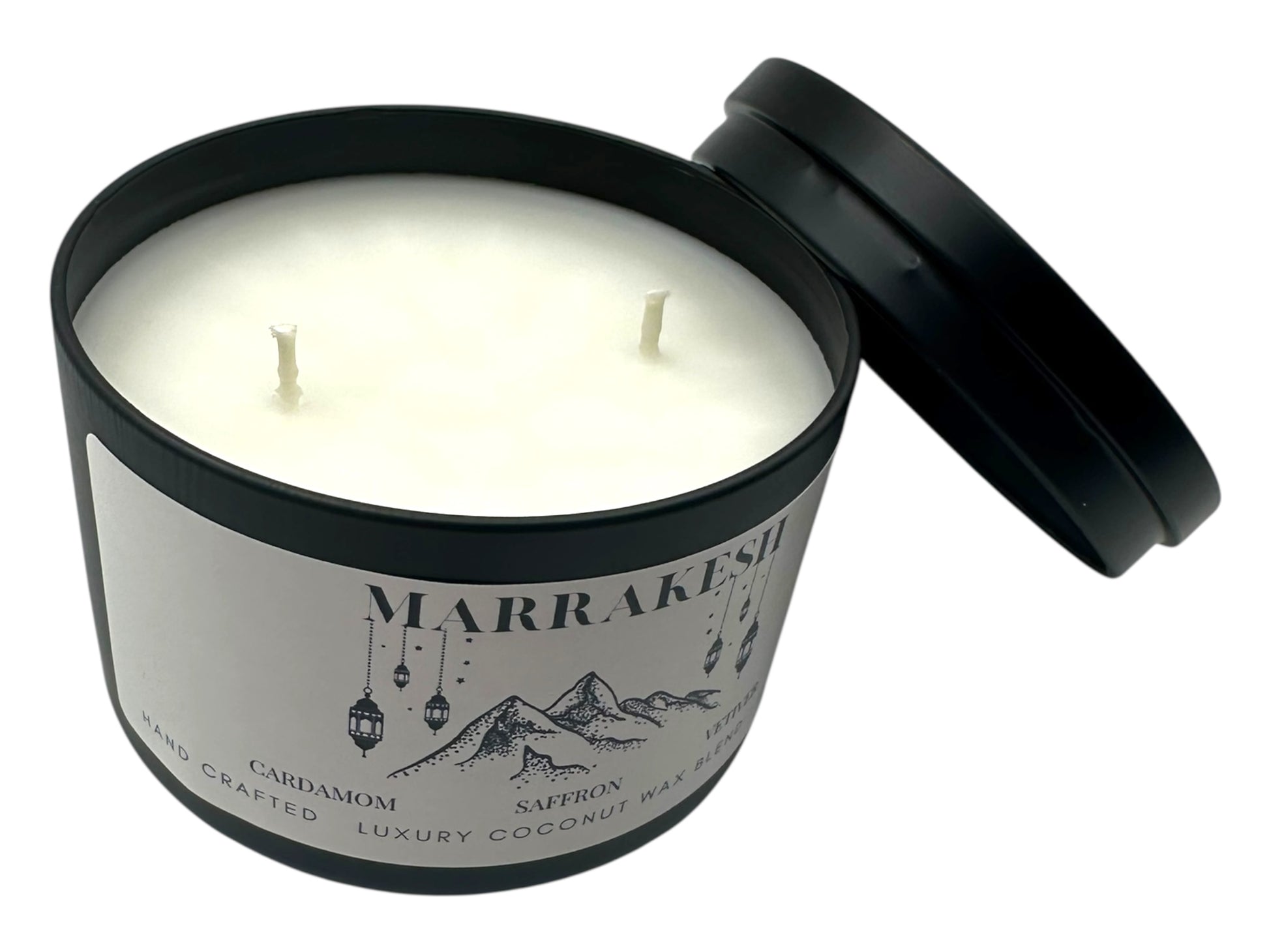 A black candle tin labeled "Marrakesh" lid removed two wicks and smooth white candle top on a white background.