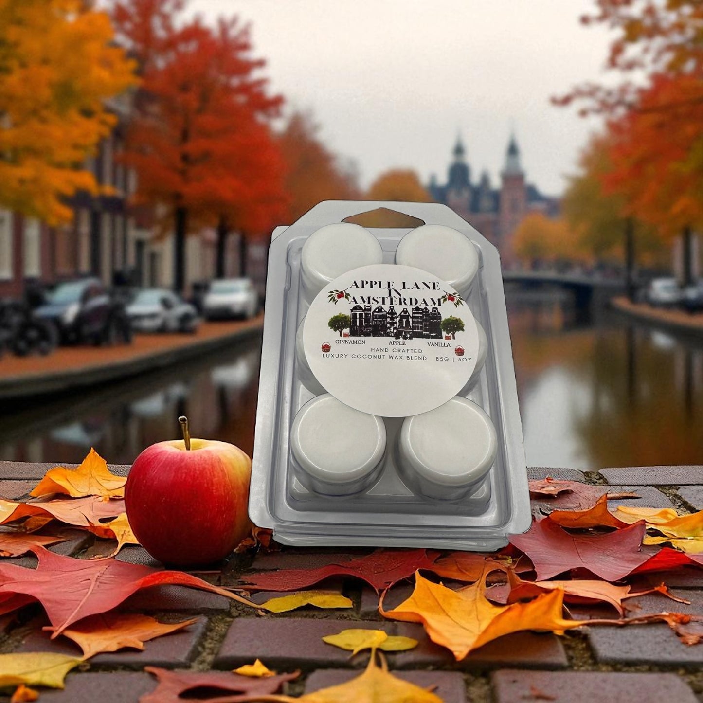 A package of wax melts labeled "Apple Lane in Amsterdam" with a scene of Amsterdam in Autumn in the background.