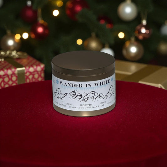 Candle jar labeled 'Wander in White' on a red surface with a Christmas tree in the background.