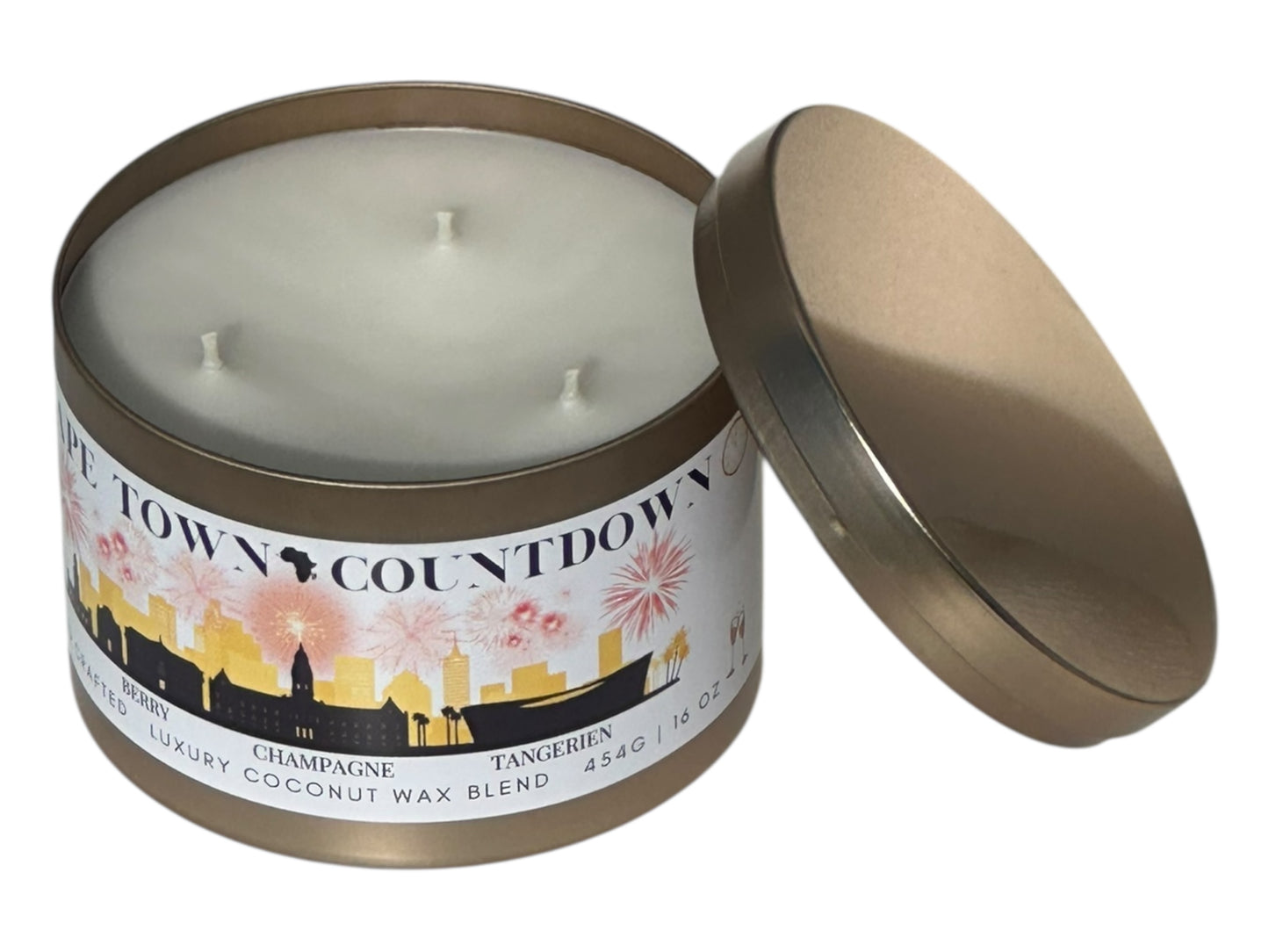 A new years gold candle tin labeled "Cape Town Countdown" on a white background front and top view with candle lid removed and sitting next to candle.