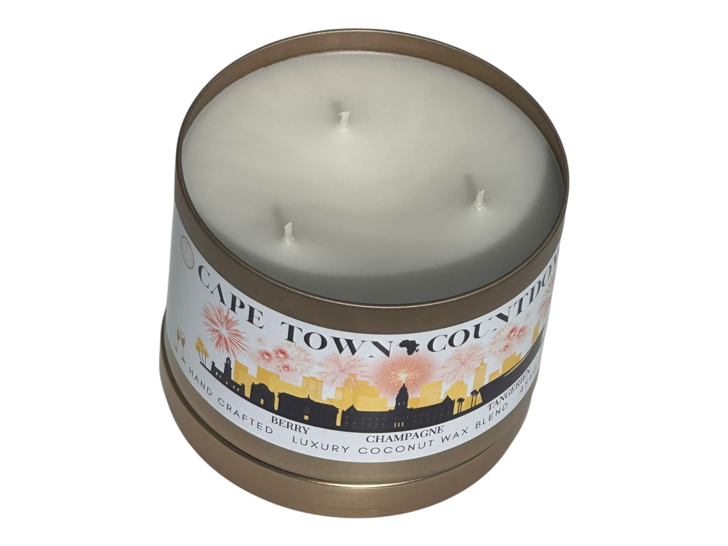 A new years gold candle tin labeled "Cape Town Countdown" on a white background front view with candle lid removed resting underneath candle.