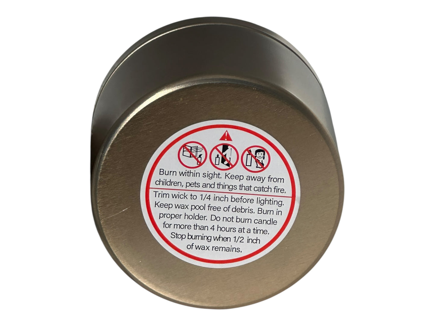 A gold Candle container with warning label on a white background.