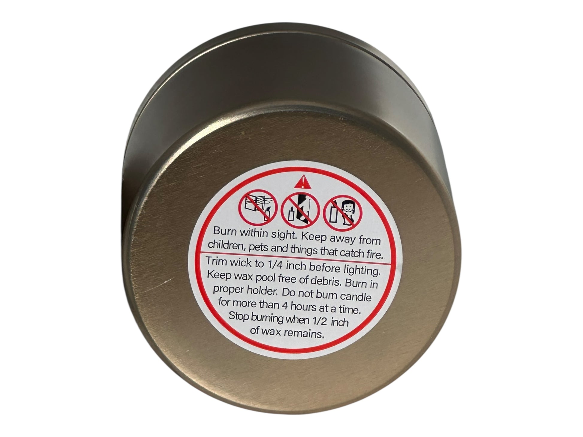 A gold Candle container with warning label on a white background.