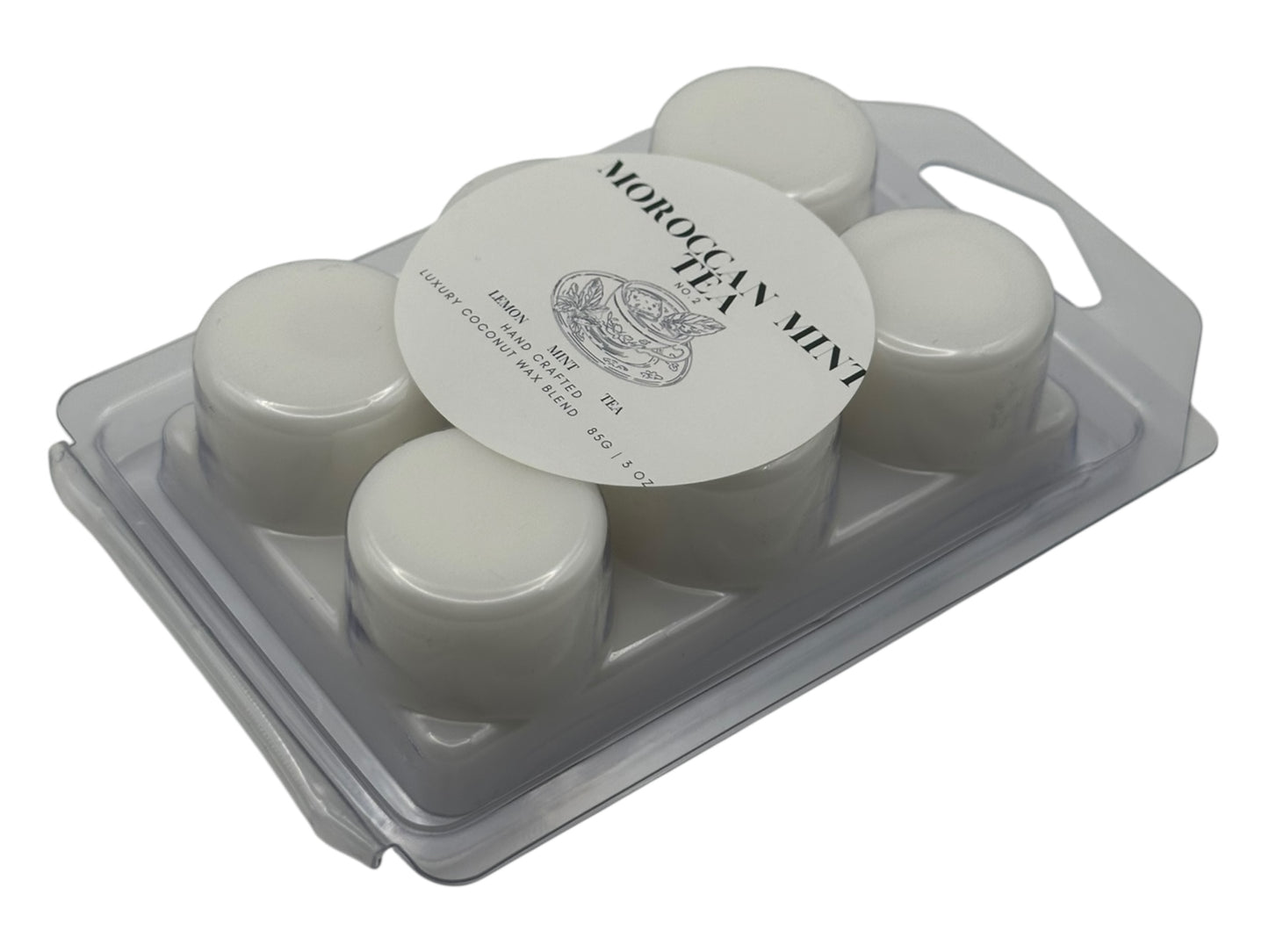 A white wax melt in clear clamshell labeled Moroccan Mint Tea  top view on a white background.