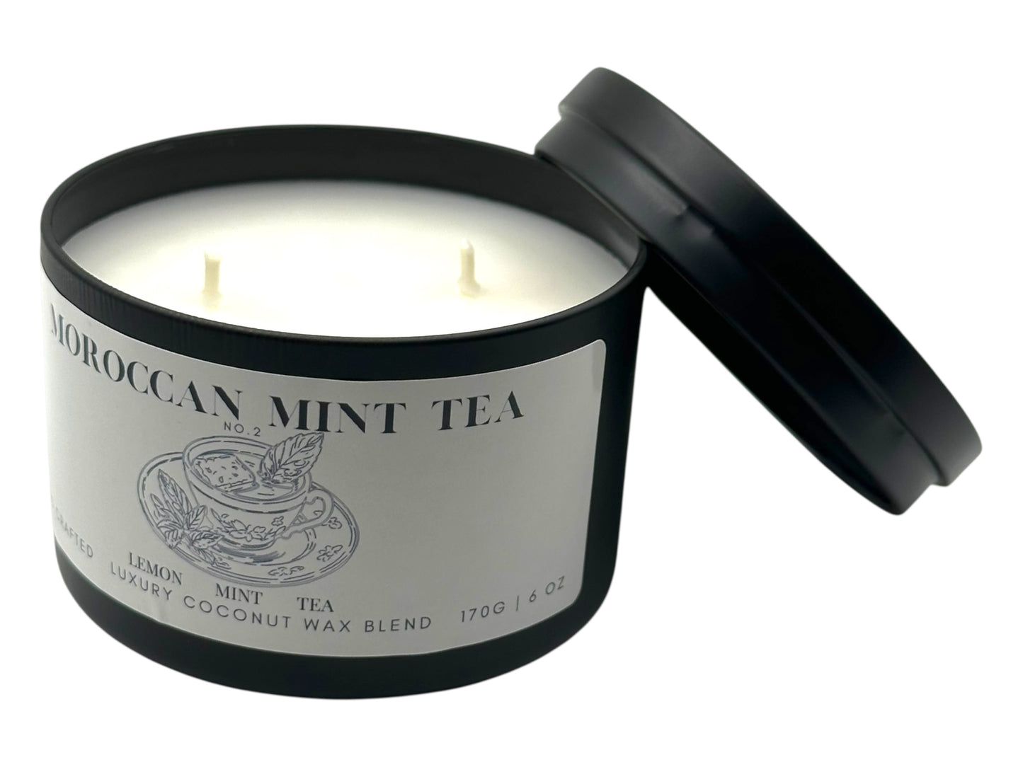 Candle in a black container labeled 'Moroccan Mint Tea' on a white background