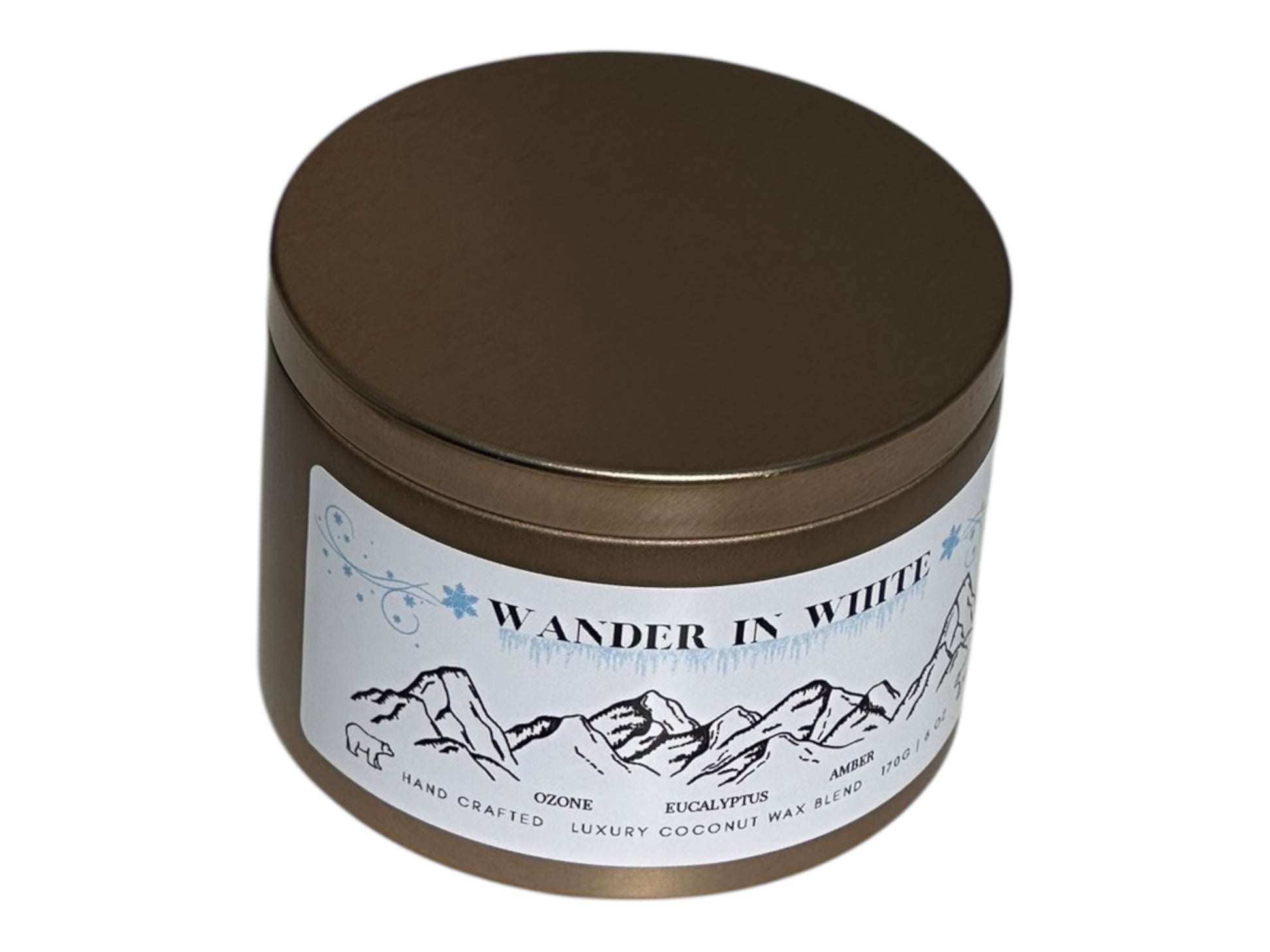 A gold candle tin with 'Wander in White' label on a white background