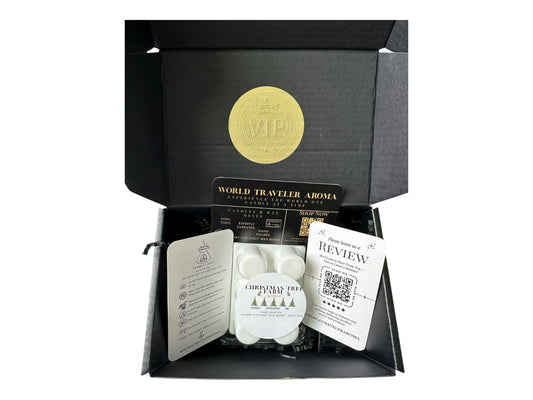 A holiday gift box with a golden VIP Sticker on the lid and inside the box a wax melt labeled "Christmas Tree Farm" Wax melt care card, please review us card, and World Traveler Aroma business card on a white background.