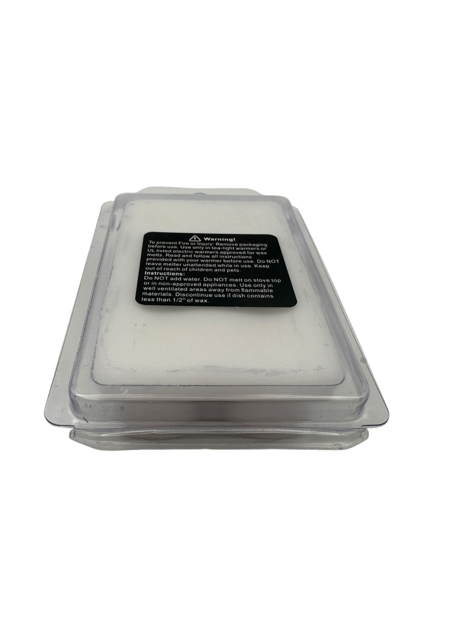 A plastic clamshell of white wax melts with a safety warning label on a white background. 