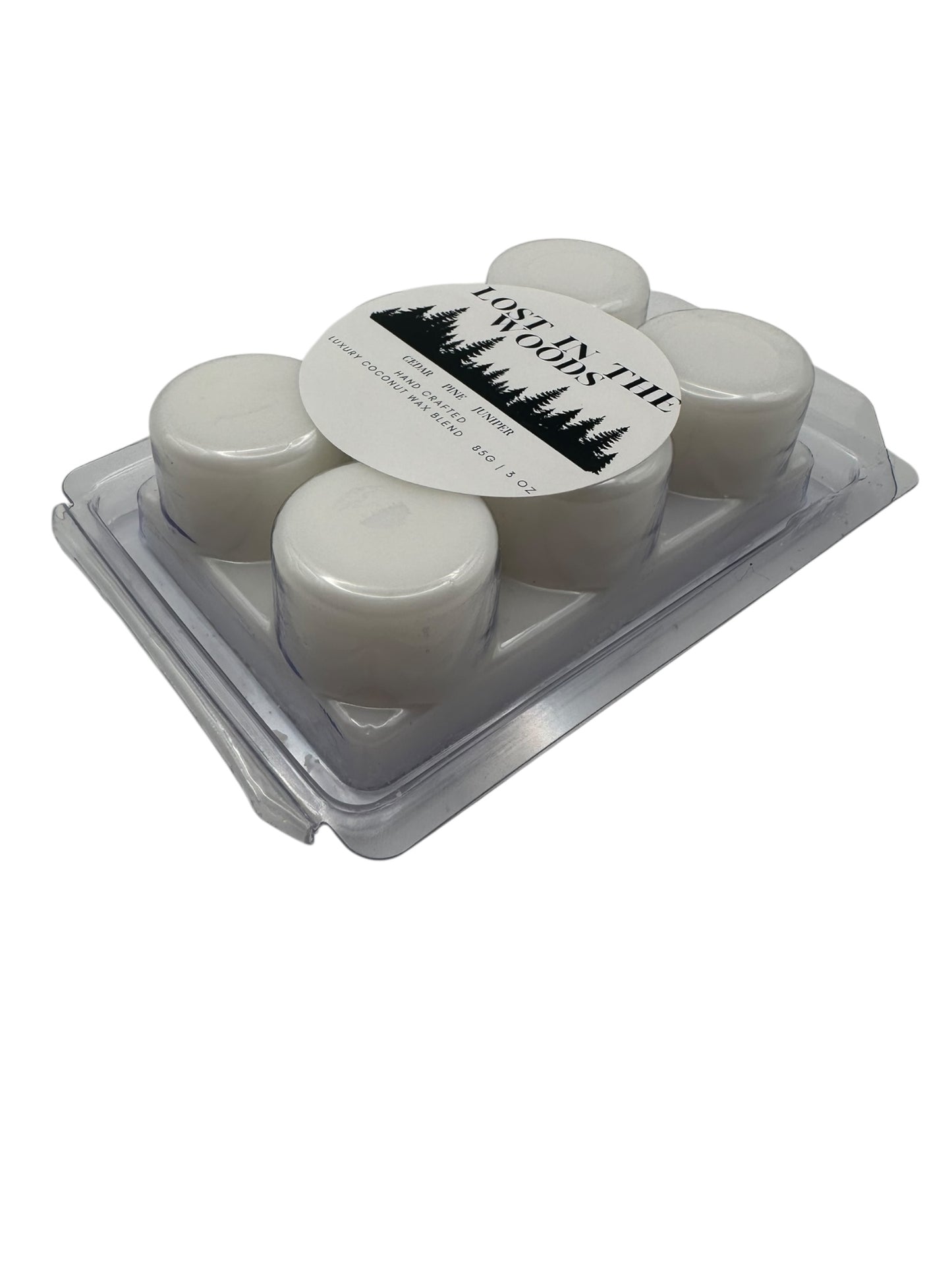 Opposite side view a plastic clamshell white wax melts labeled "Lost in the Woods" on a white background. 