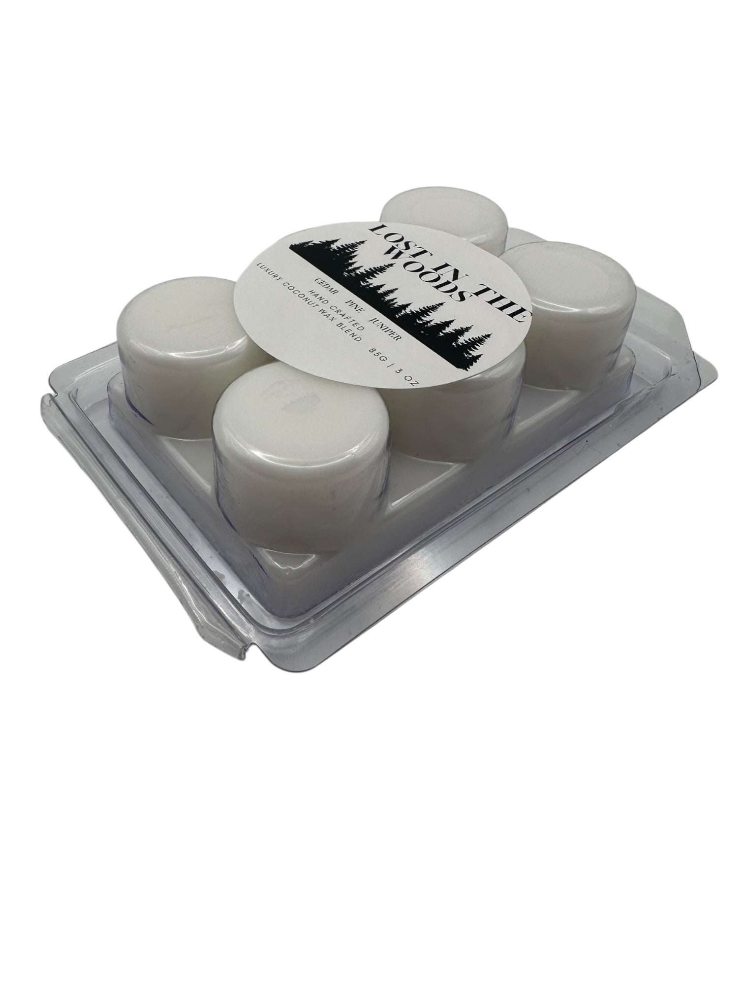 Opposite side view a plastic clamshell white wax melts labeled "Lost in the Woods" on a white background. 
