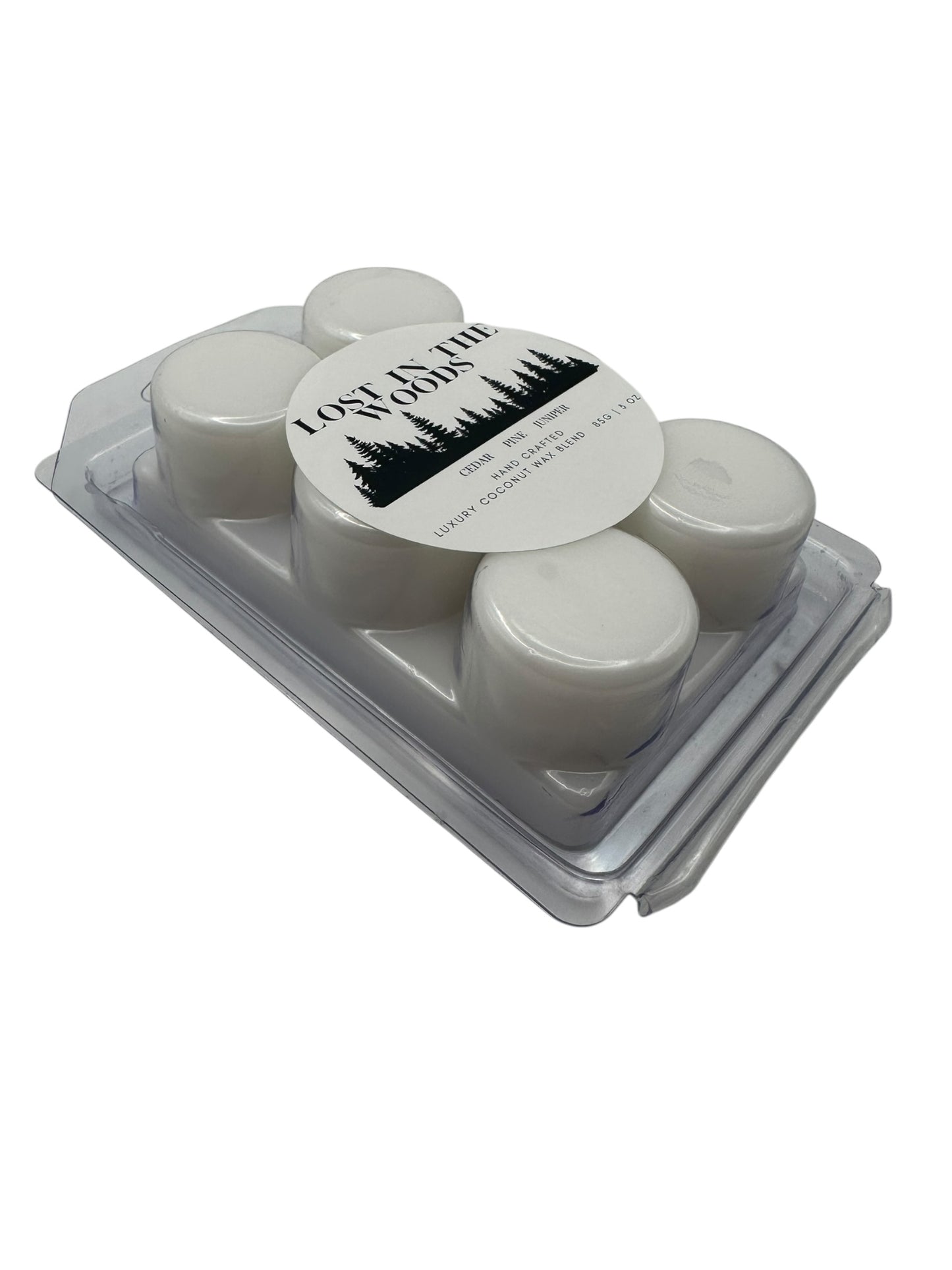 Side view a plastic clamshell white wax melts labeled "Lost in the Woods" on a white background. 