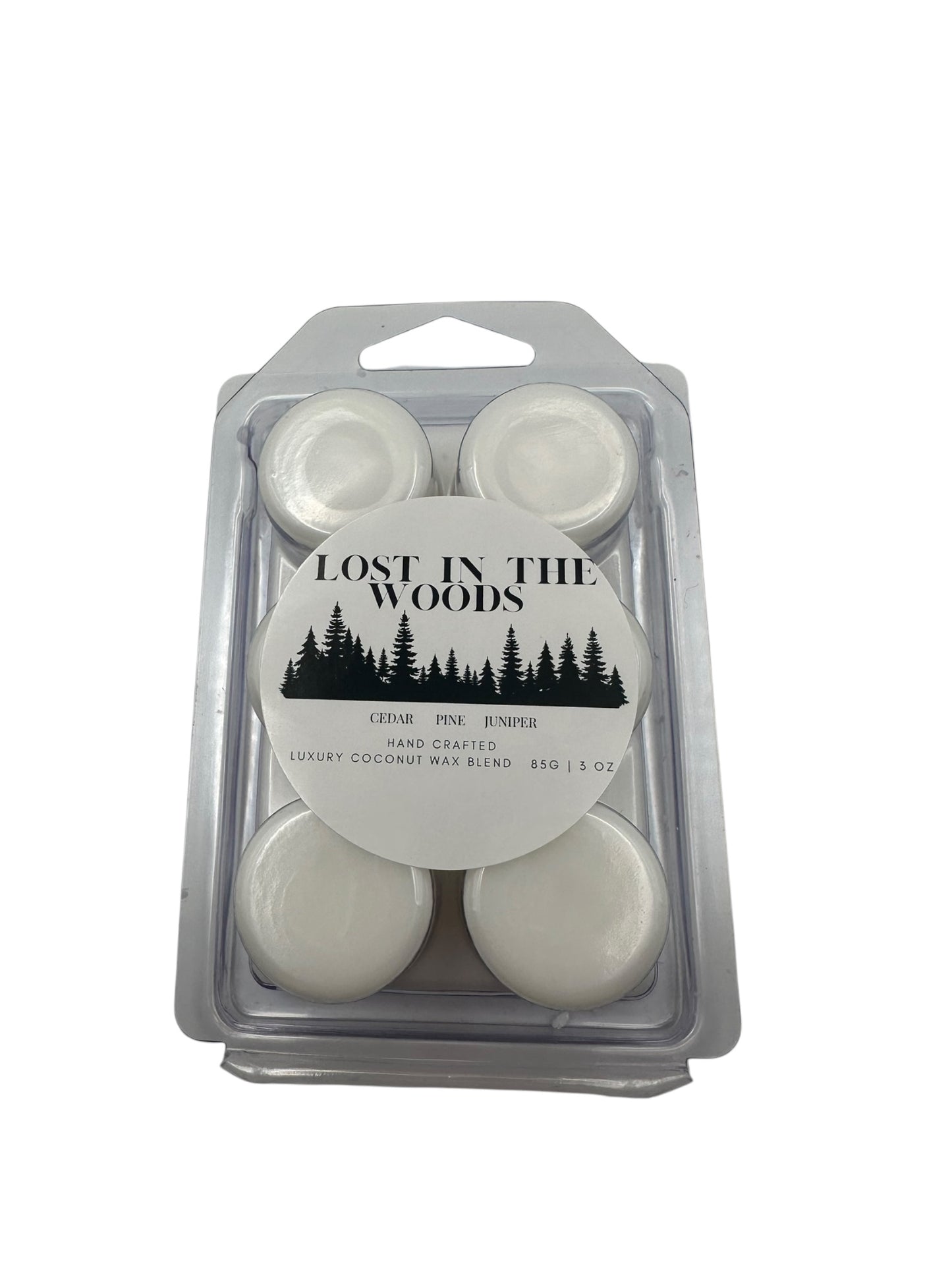 A plastic clamshell white wax melts labeled "Lost in the Woods" on a white background. 