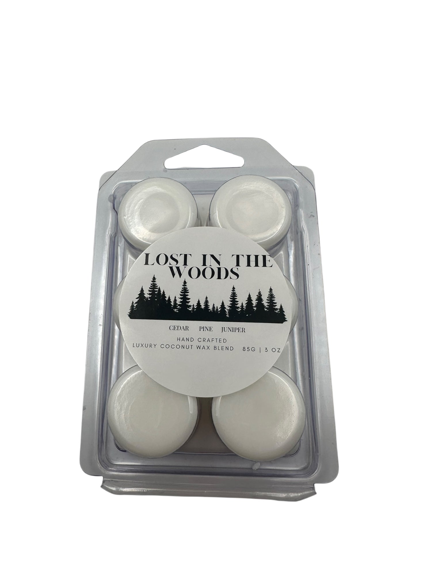 A plastic clamshell white wax melts labeled "Lost in the Woods" on a white background. 