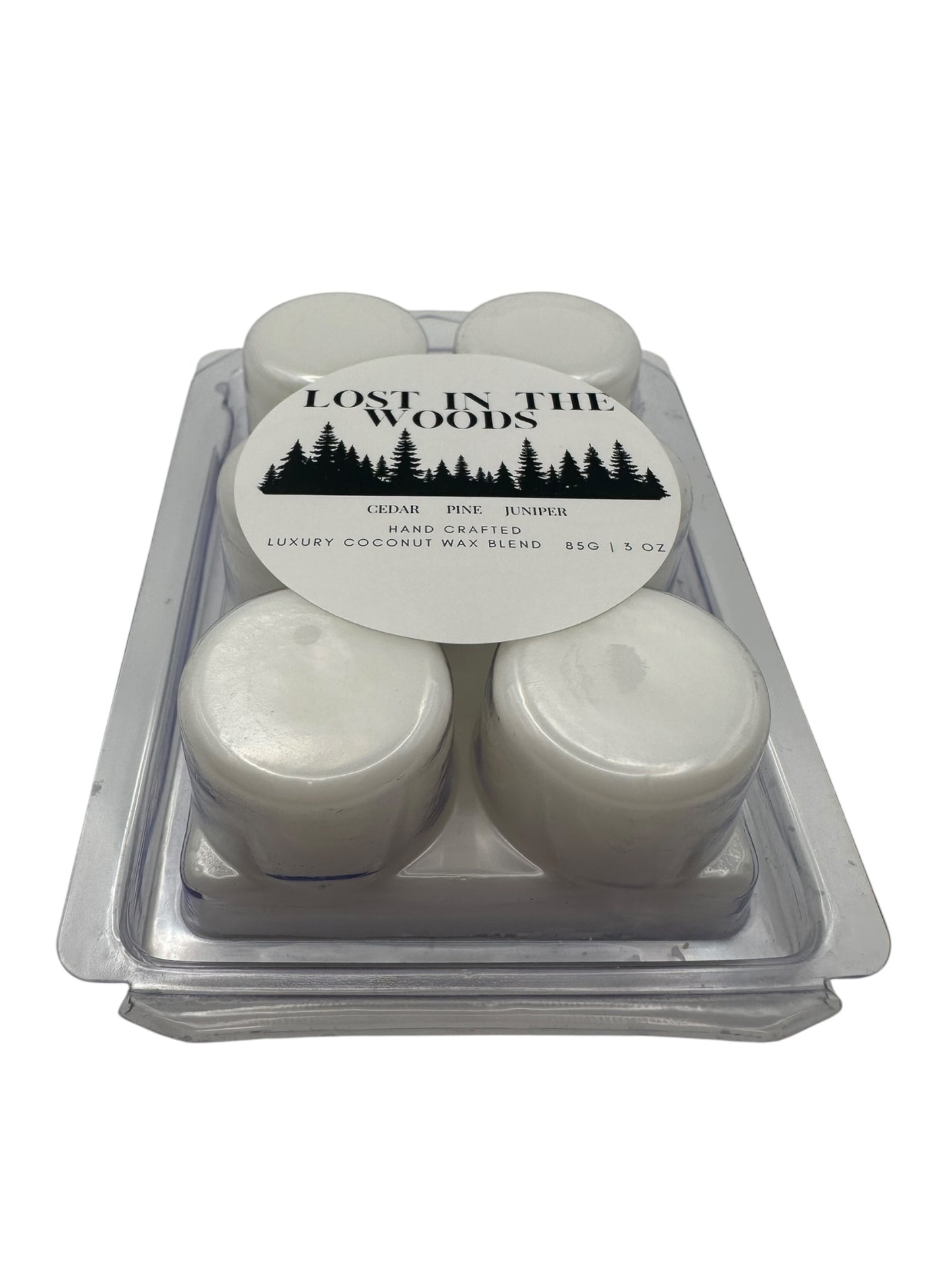 A plastic clamshell white wax melts labeled "Lost in the Woods" on a white background. 