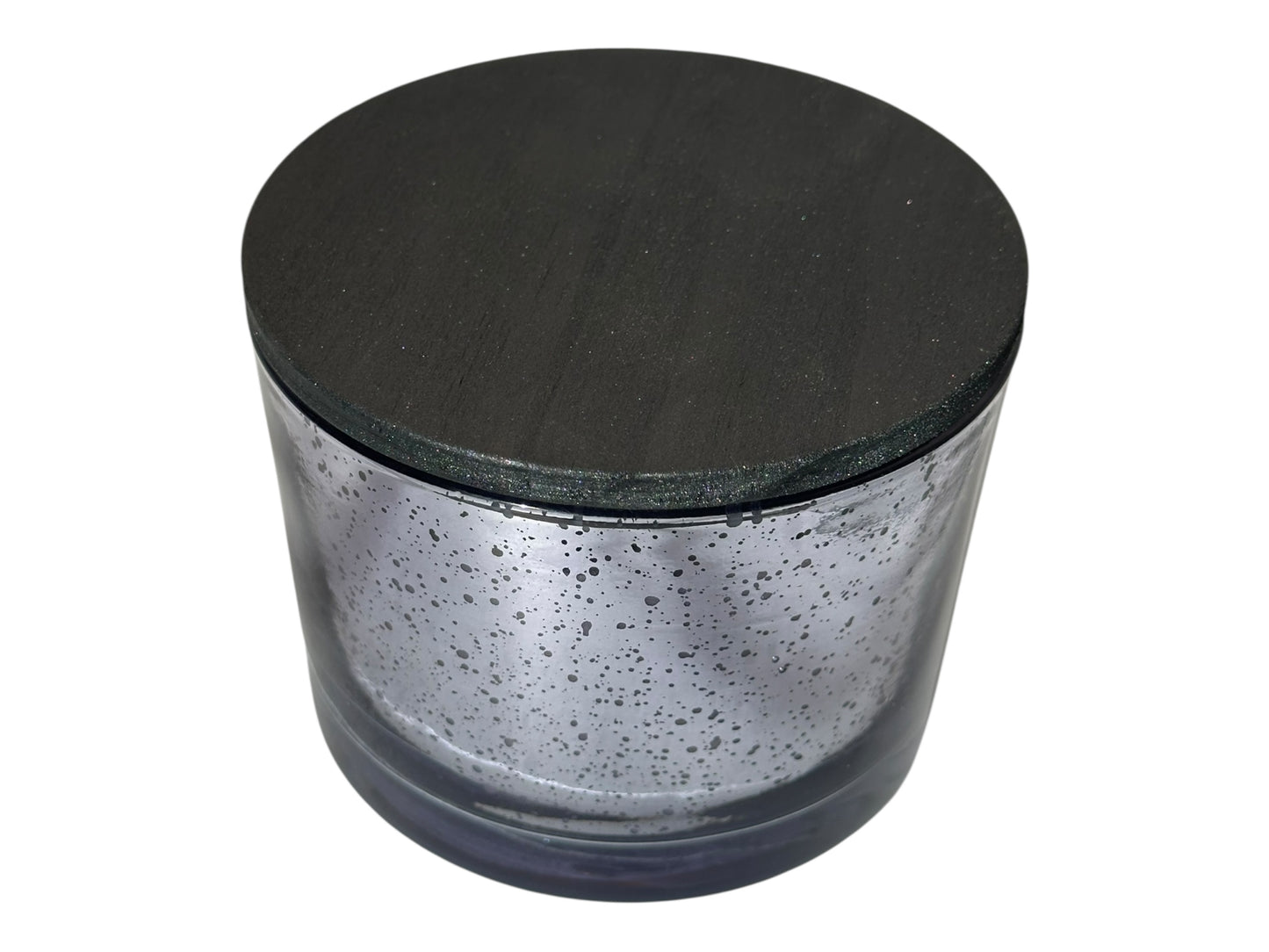 A purple glass candle container with a black lid on a white background.
