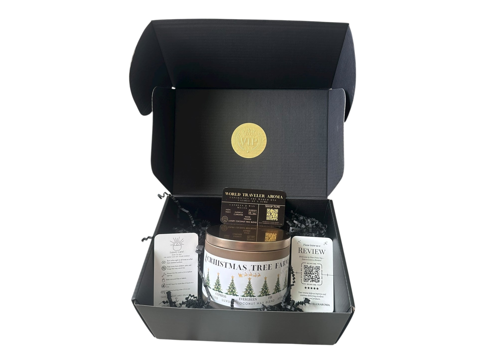 A black gift box with a gold VIP sticker on the lid inside the box a gold candle tin labeled "Christmas Tree Farm" a candle care care instructions, a please review us card, and a World Traveler Aroma business card on a white background.