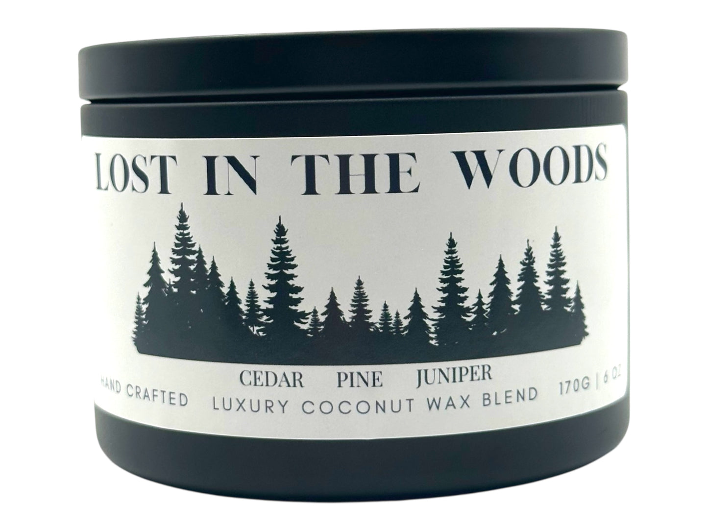 A black candle tin labeled "Lost in the Woods" on a white background. 