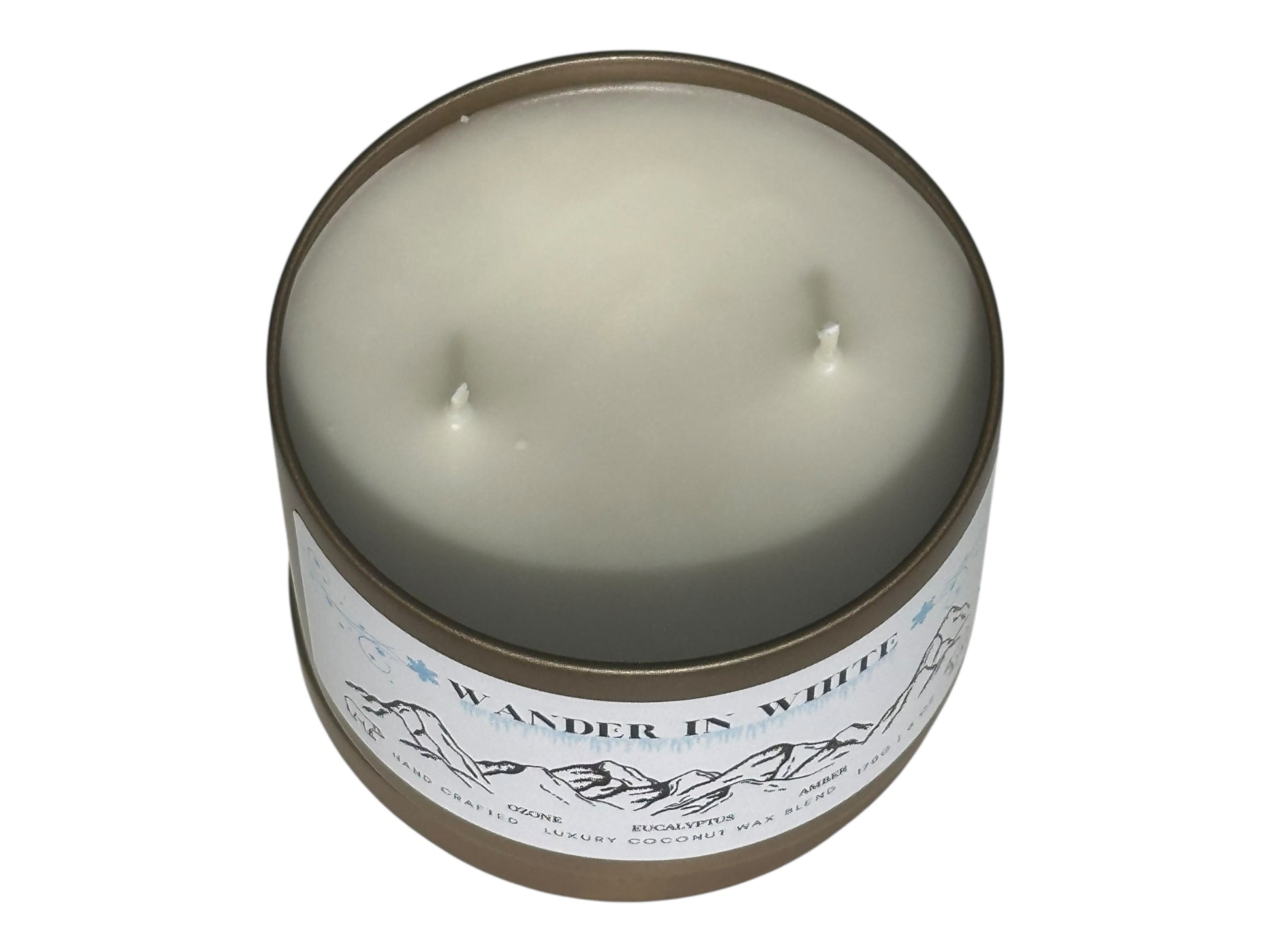 A gold candle tin labeled "Wander in White" with lid removed displaying two candle wicks on top on a white background.