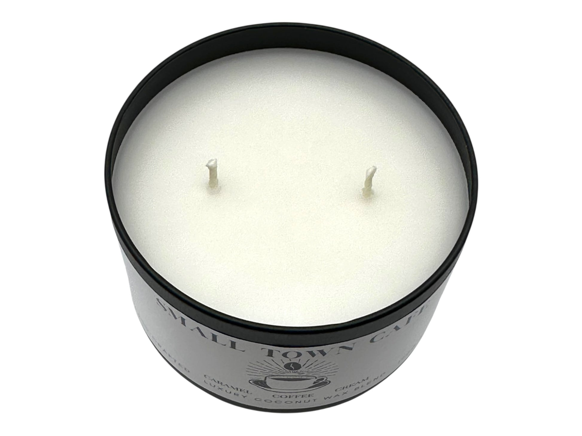 A black candle tin labeled "Small Town Cafe" with lid removed showing two candle wicks and a smooth white candle top on a white background.