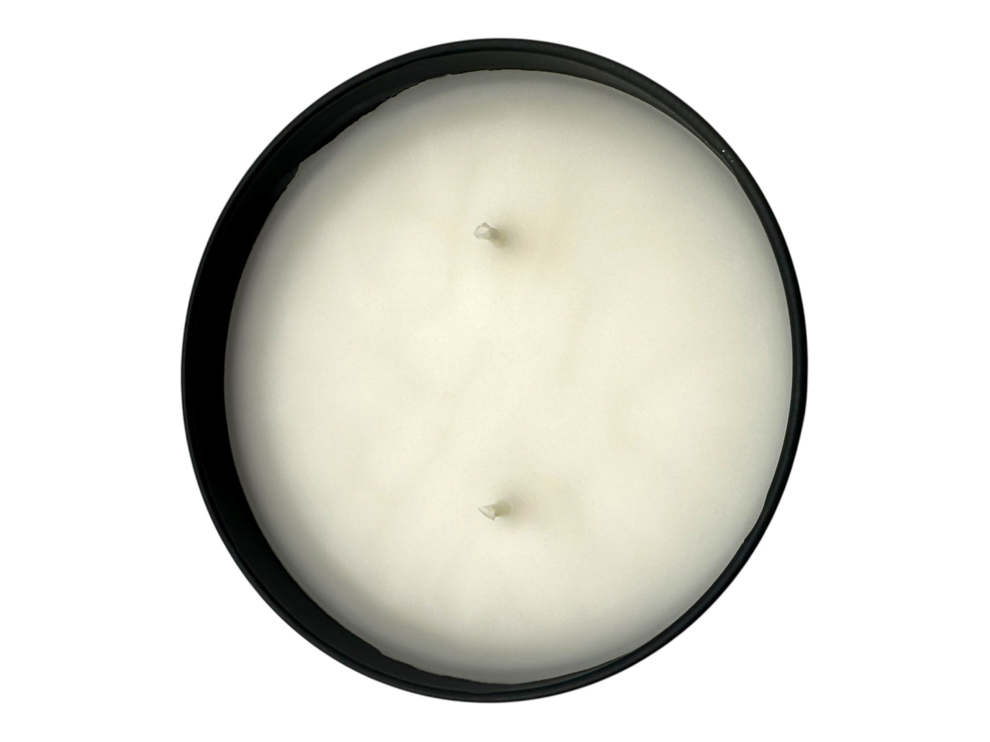A black candle tin no lid with two wicks and a smooth white candle top.