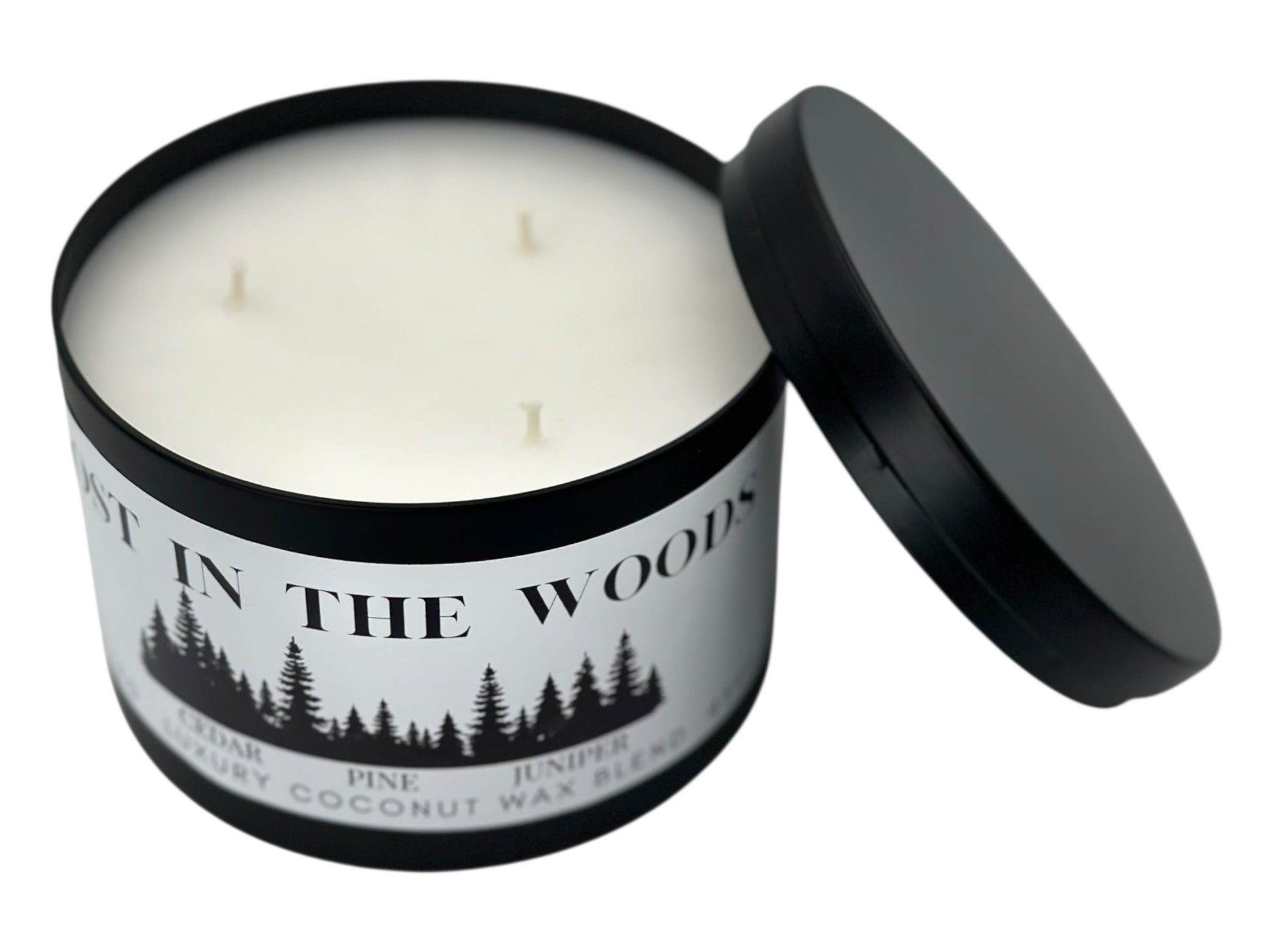 A black candle tin labeled "Lost in the Woods" with lid removed showing three wicks and a smooth white candle top on a white background.