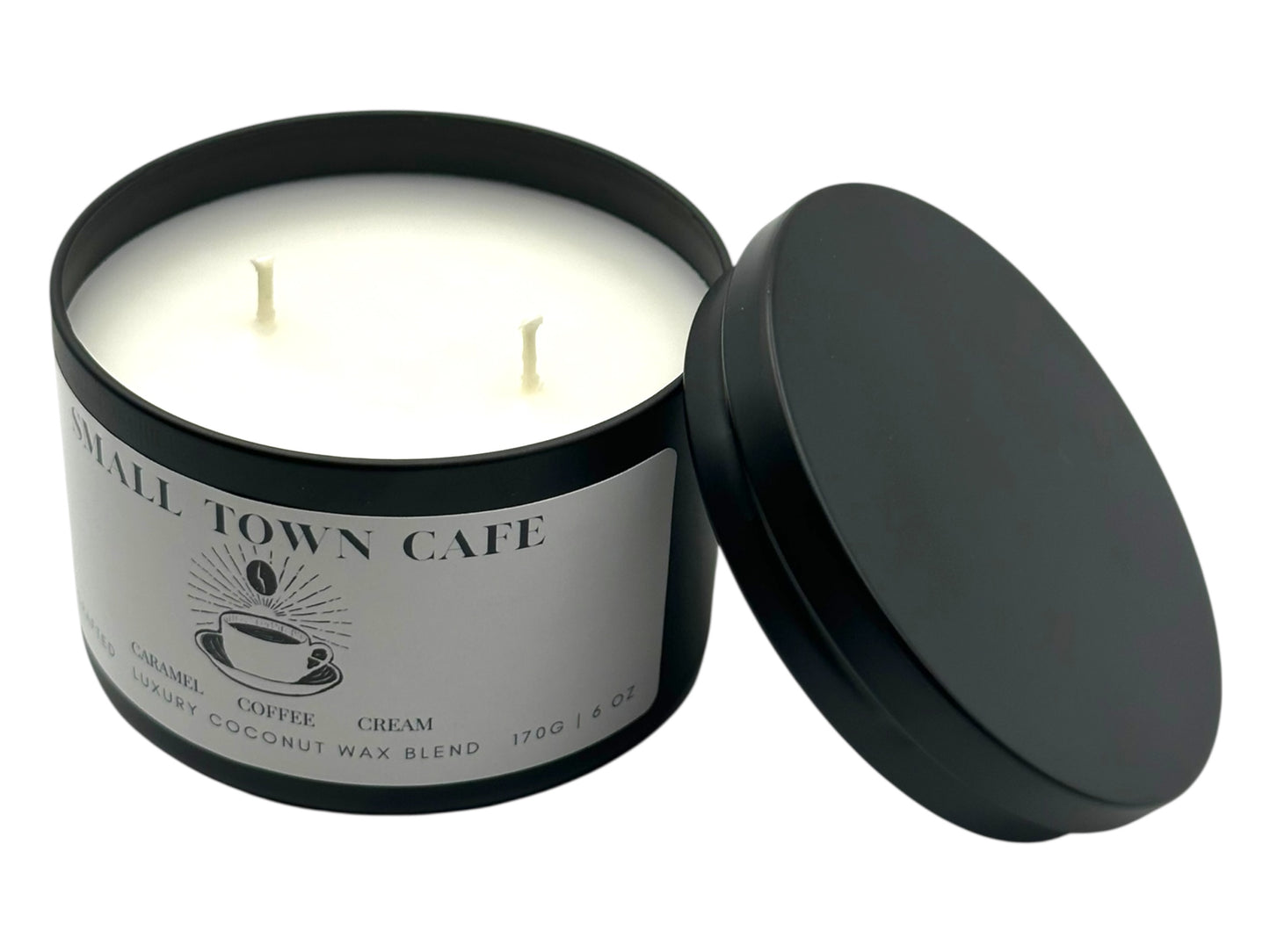 A black candle tin labeled "Small Town Cafe" with the lid removed on a white background.