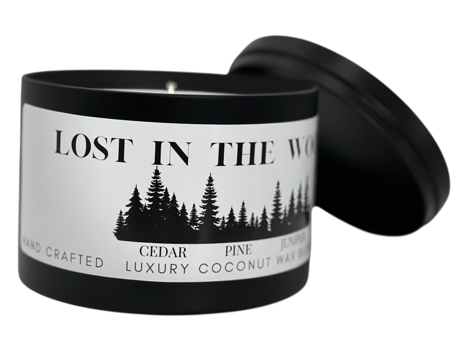 A black candle tin labeled "Lost in the Woods" with lid removed on a white background.