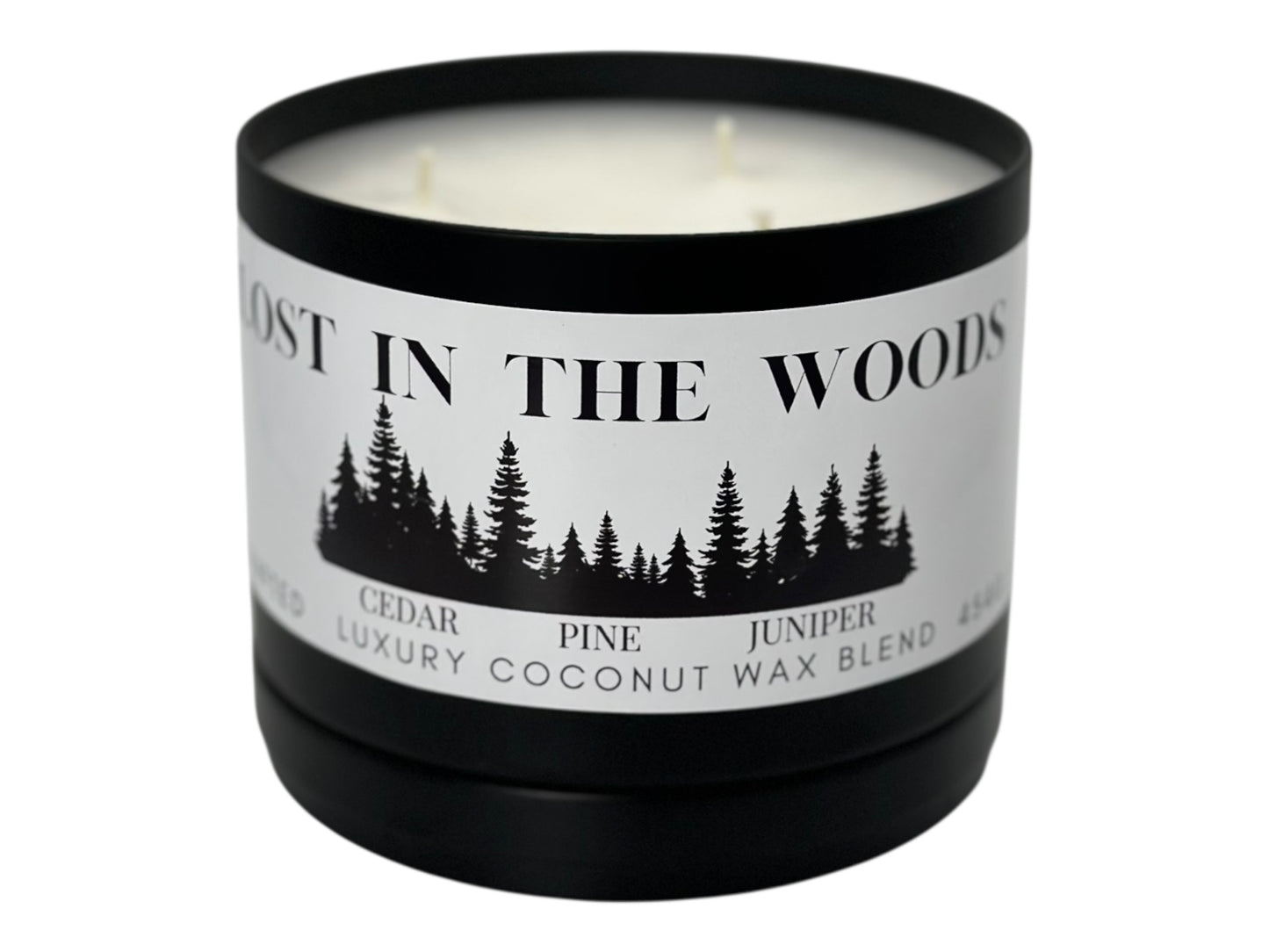 A black candle tin labeled "Lost in the Woods" with lid removed on a white background.