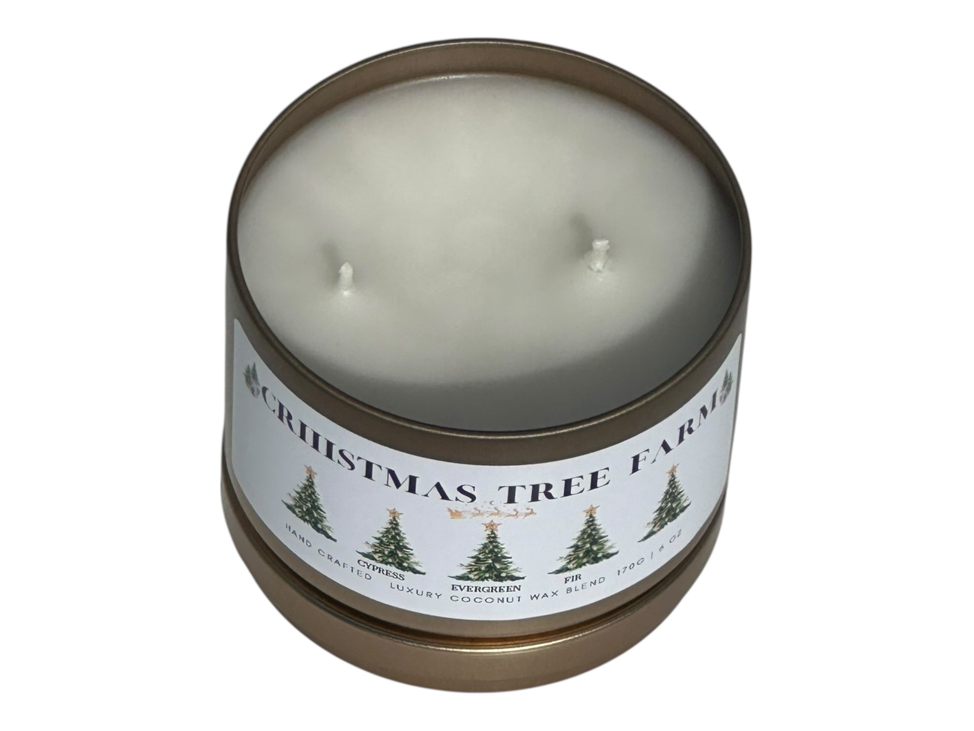 a gold candle tin labeled "Christmas Tree Farm" with lid removed on a white background front view with lid under candle.