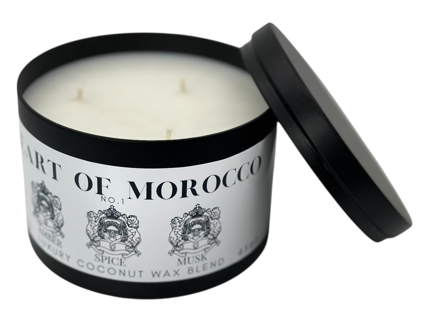 A black candle tin labeled "Heart of Morocco" lid removed showing three wicks and a smooth white candle top on a white background.
