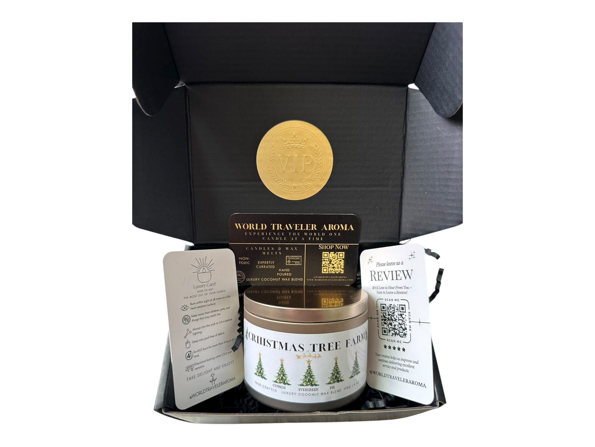 A black gift box with a gold VIP sticker on the lid inside the box a gold candle tin labeled "Christmas Tree Farm" a candle care care instructions, a please review us card, and a World Traveler Aroma business card on a white background.