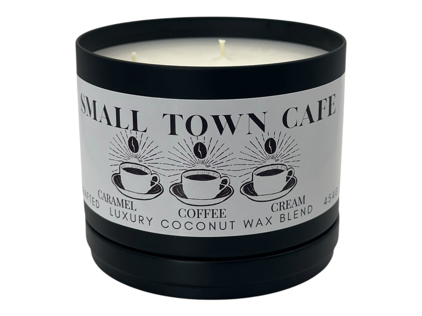 A black candle tin labeled "Small Town Cafe" with lid removed on a white background.