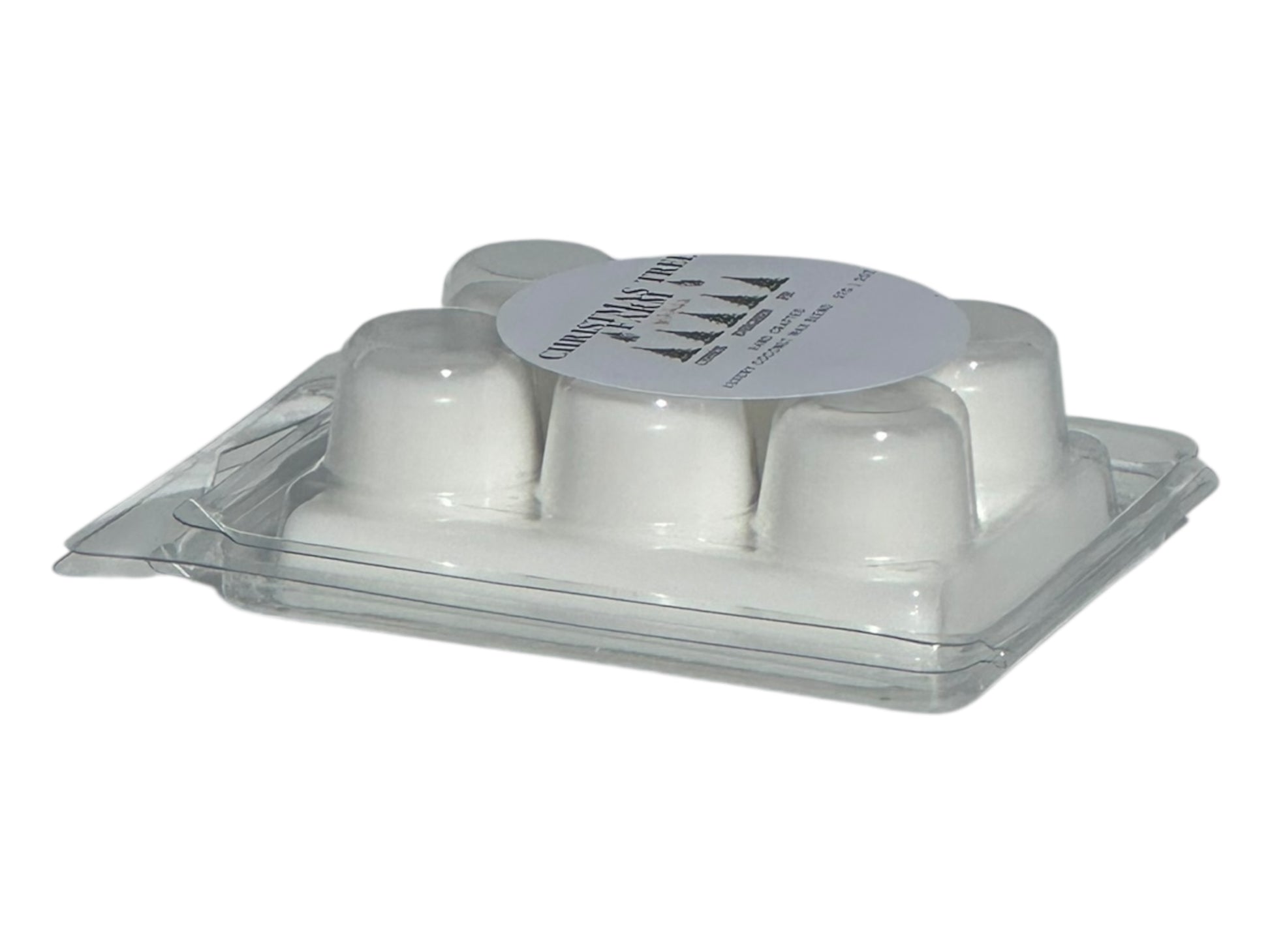  winter wax melt labeled "Christmas Tree Farm" on a white background side view at an angle to show depth with natural lighting.