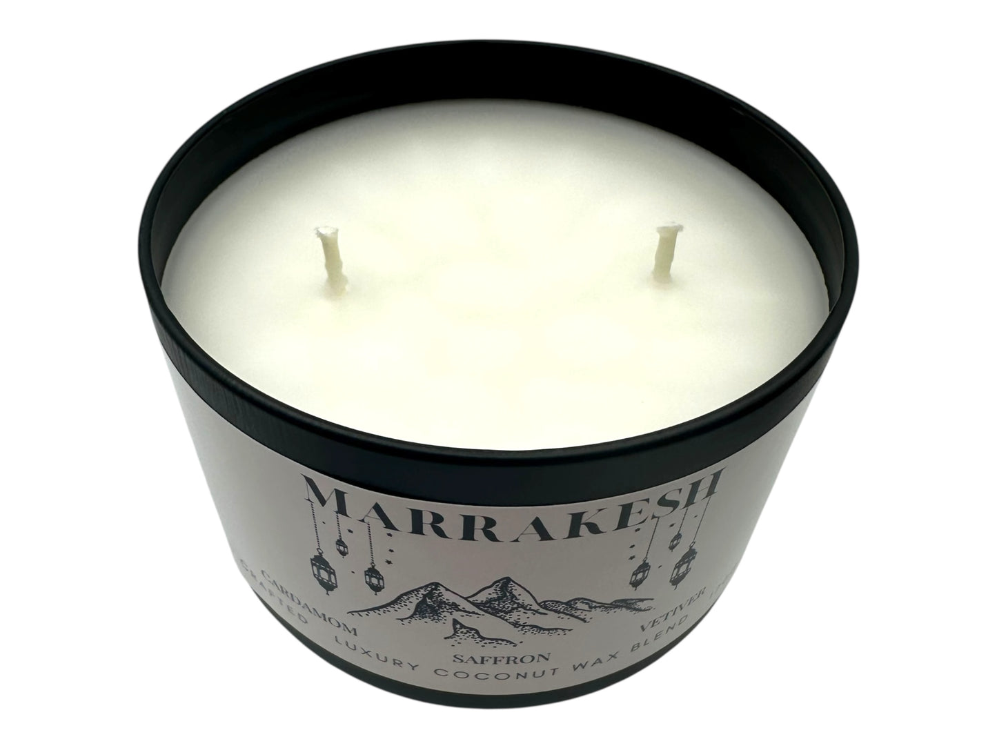 A black candle tin labeled "Marrakesh" two wicks smooth white candle top on a white background. 