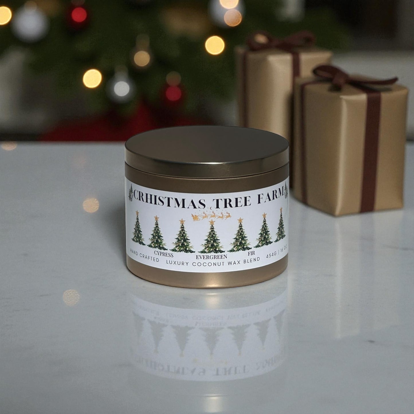 A gold candle tin labeled, "Christmas Tree Farm" sitting on a white marble counter top next to Christmas presents with a Christmas tree in the background.