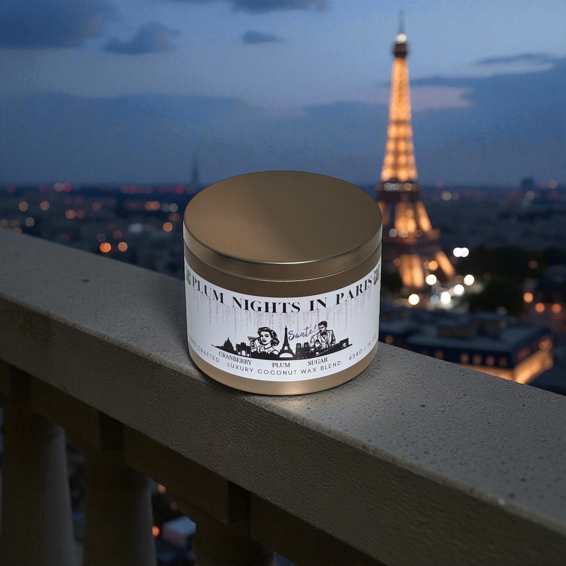 A gold candle tin labeled "Plum Nights in Paris" with retro digital art on the label sitting on a balcony ledge over looking the Eiffel Tower at dusk.