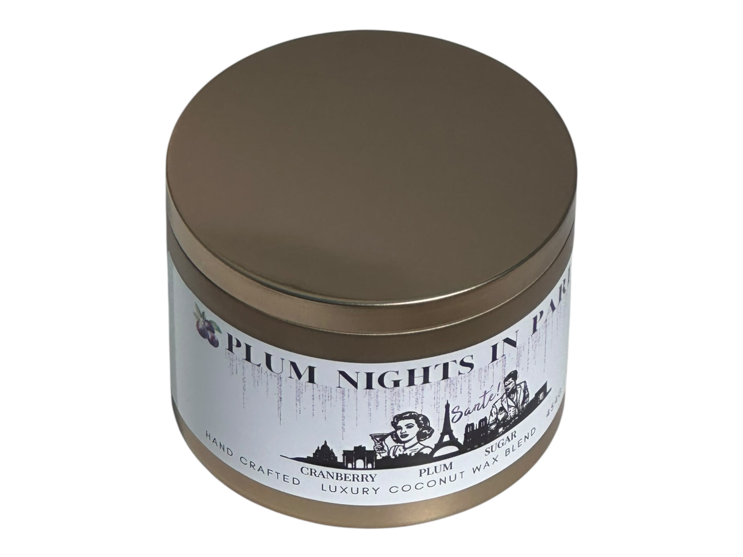A gold candle tin labeled "Plum Nights in Paris" on a white background side view.