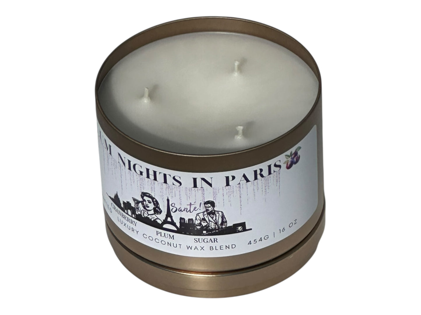 A gold candle tin labeled "Plum Nights in Paris" on a white background front view with candle lid removed.