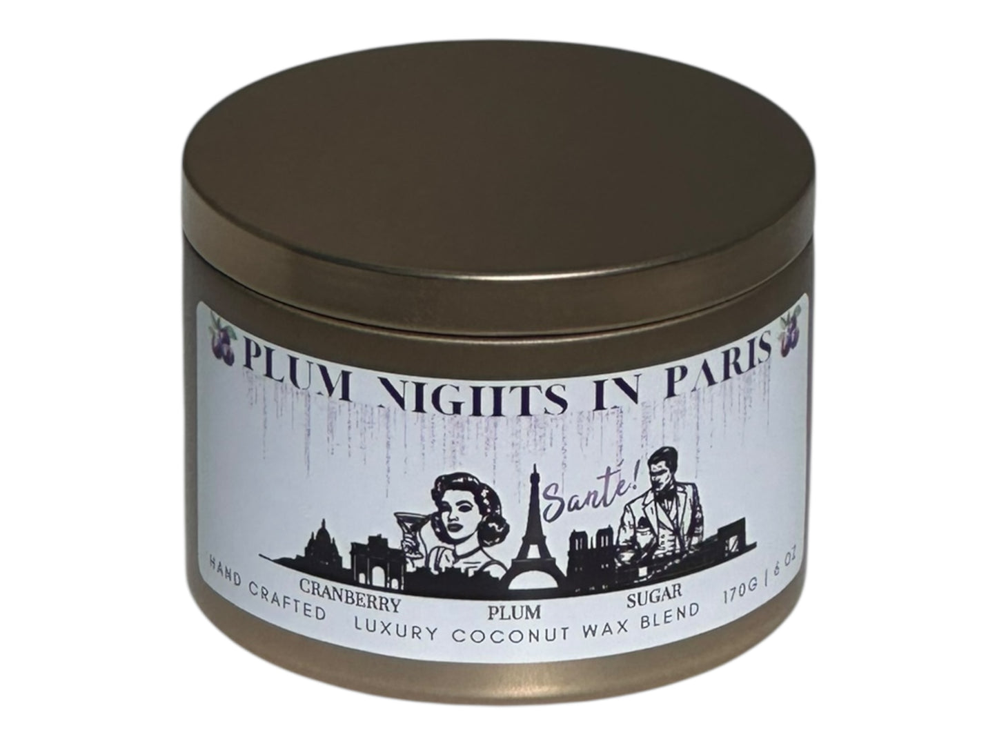 A gold candle tin labeled, "Plum Nights in Paris" on a white background.