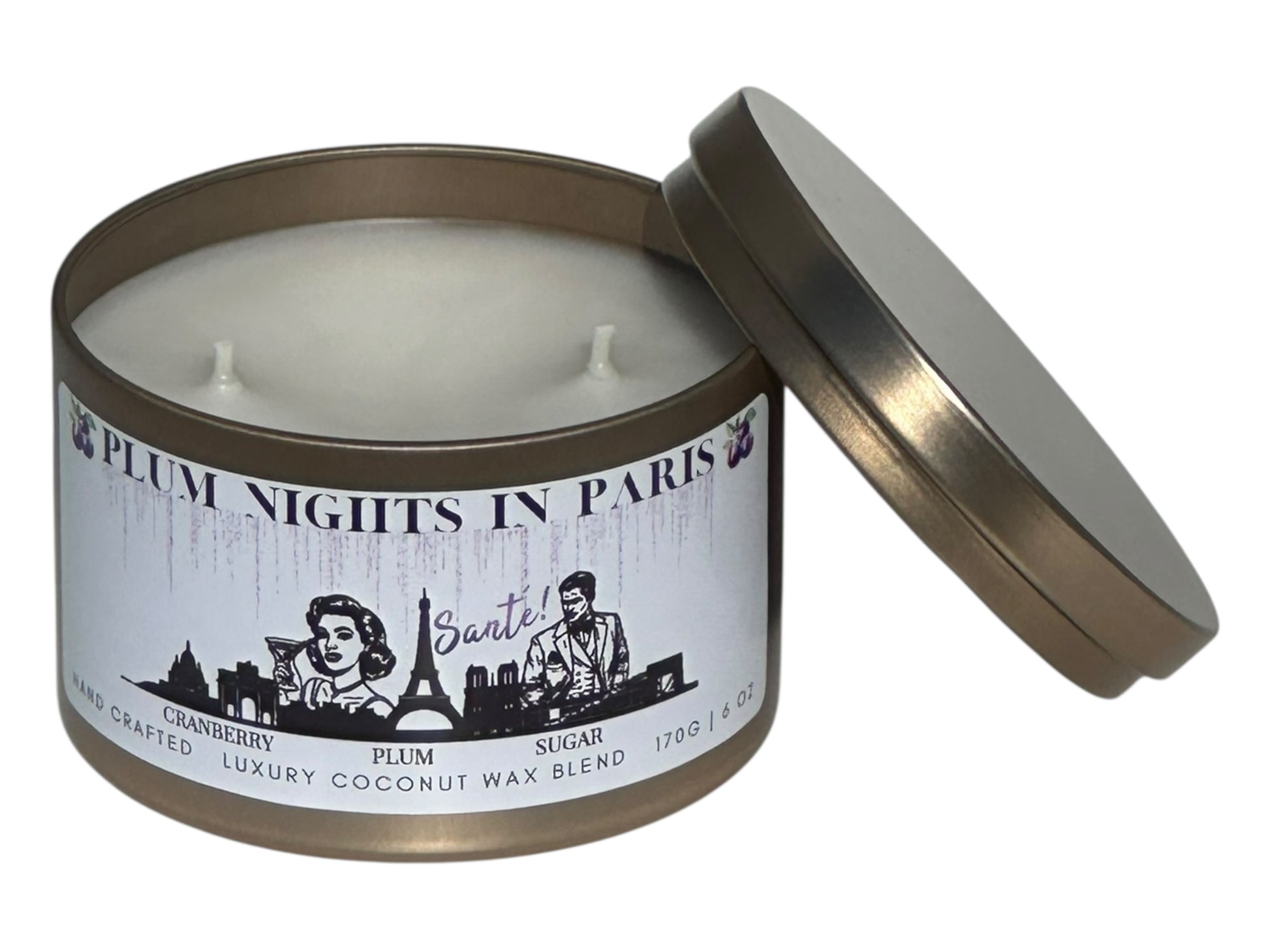 A gold candle tin labeled, "Plum Nights in Paris" on a white background with lid removed showing two candle wicks.