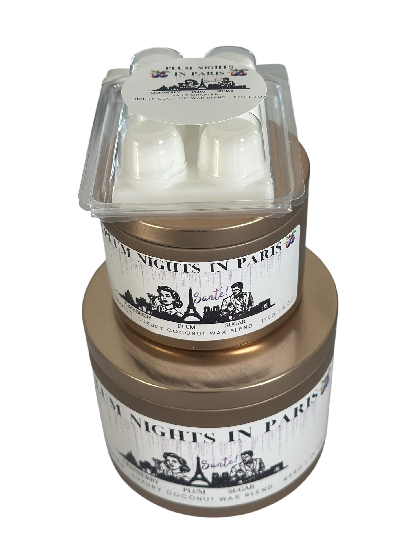 A Christmas collection of gold candle tins and white wax melts labeled "Plum Nights in Paris" on a white background.